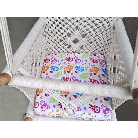 Coussin doux et coloré dans hamac macramé écru pour confort optimal