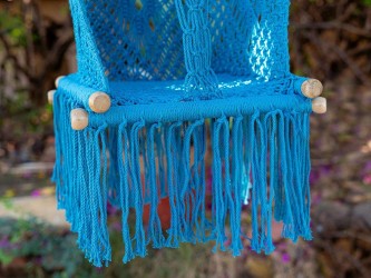 Détail du tissage en macramé bleu du hamac pour bébé suspendu avec des franges décoratives