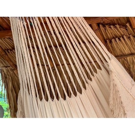 Vue rapprochée du tissu de couleur écru ou beige du hamac colombien, avec le détail du motif diamants tissé sur les bords