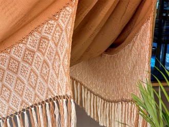 Détail du tissage artisanal du hamac DUNA, motif beige et blanc avec franges décoratives