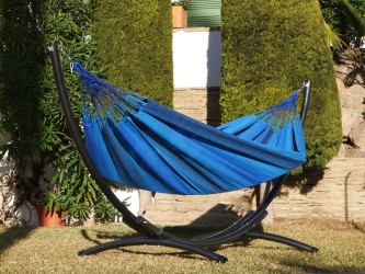 Un hamac colombien aux tons bleus installé sur un support en métal noir. Idéal pour créer un coin détente élégant dans le jardin