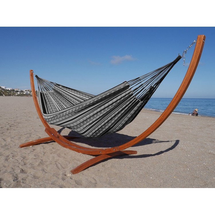 Hamac polygone noir XL avec support en bois, au bord de la mer