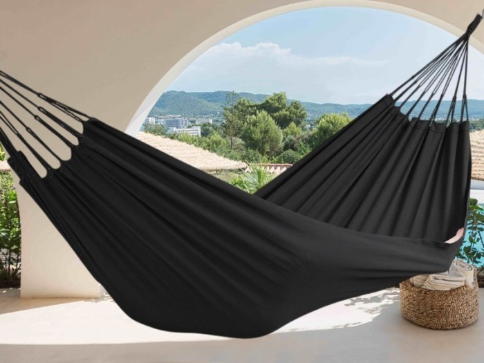 Hamac noir, suspendu sur une terrasse avec vue sur les montagnes