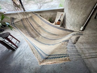 Hamac Moriche à rayures bleues vu de dessus sur une terrasse rustique