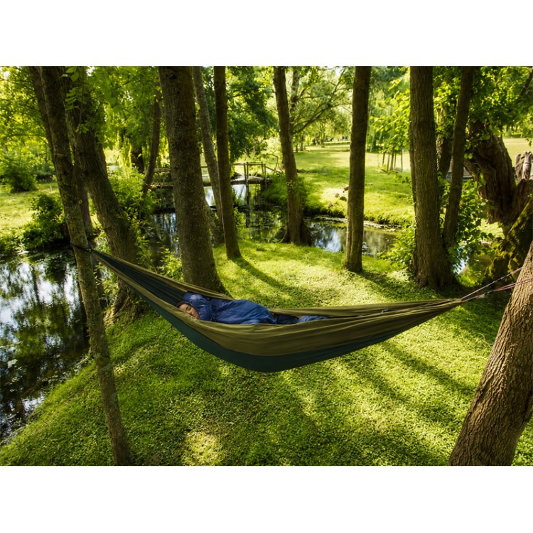 Hamac outdoor flex XL vert installé entre deux arbres en pleine nature, idéal pour la détente en extérieur